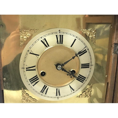 130 - Two clocks including A walnut mantel clock with a silvered dial and An oak mantle clock with key and... 