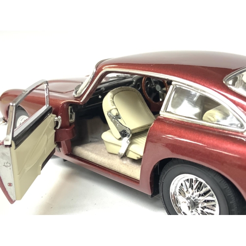 173 - A boxed Danbury Mint 1964 Aston Martin DB5 Coupe replica model. Postage category B