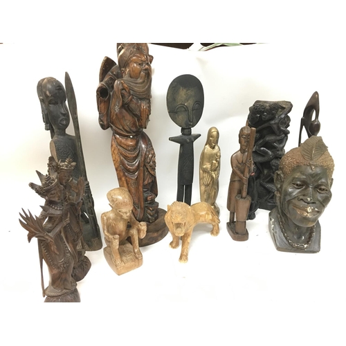 265 - A collection of carved wooden African tribal figures including a bronze bust of a tribes member