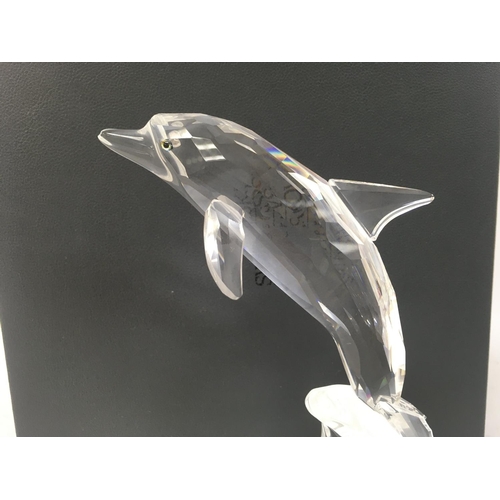 A boxed Swarovski dolphin , 20cm tall.