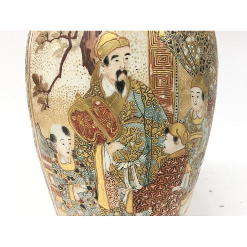 476 - A Japanese satsuma vase decorated with oriental figures. 23.5cm tall. Postage category D