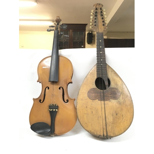 527 - A damaged twelve stringed mandolin by Giovanni Minieri, circa 1900s and a Chinese violin.