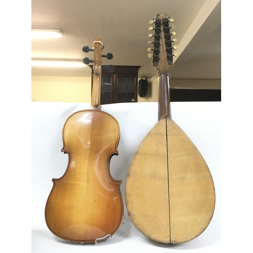 527 - A damaged twelve stringed mandolin by Giovanni Minieri, circa 1900s and a Chinese violin.