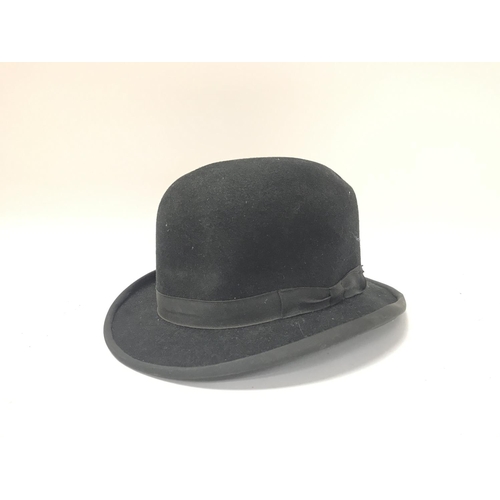 65 - A vintage Black bowler hat.