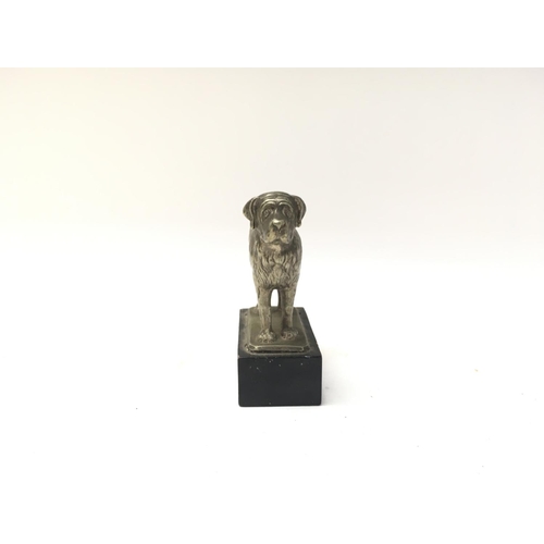 86 - A smal silver plated St Bernard figure mounted on a wooden plinth.