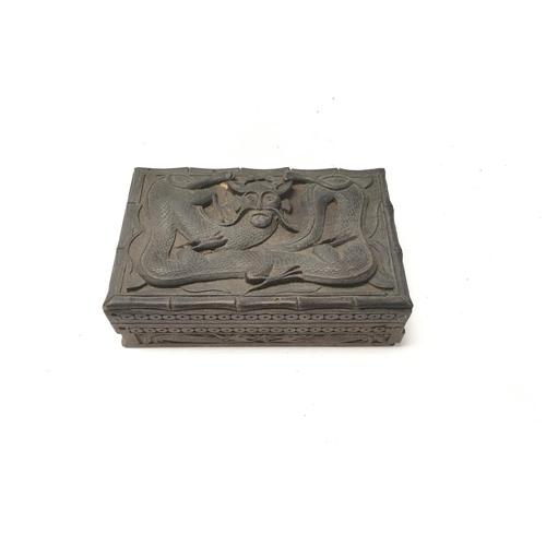 91 - A Chinese hand carved wooden dragon trinket box.