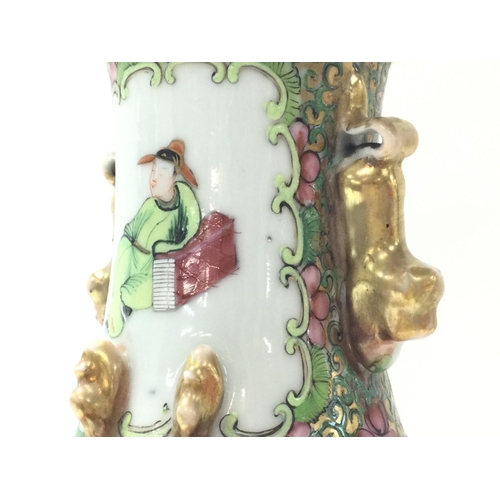 1015 - A Cantonese Famille Rose tea pot and vase. Chips at the rim of the vase and at the base. Approximate... 