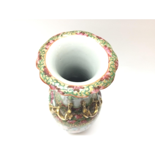 1015 - A Cantonese Famille Rose tea pot and vase. Chips at the rim of the vase and at the base. Approximate... 