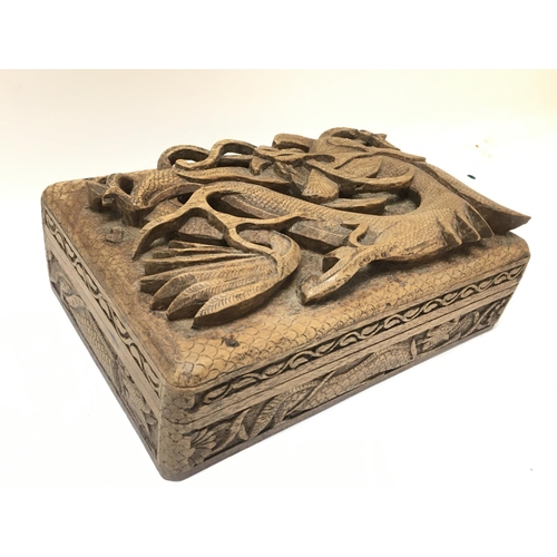 1017 - An oriental carved box with dragon decoration , 15x23x6.5cm