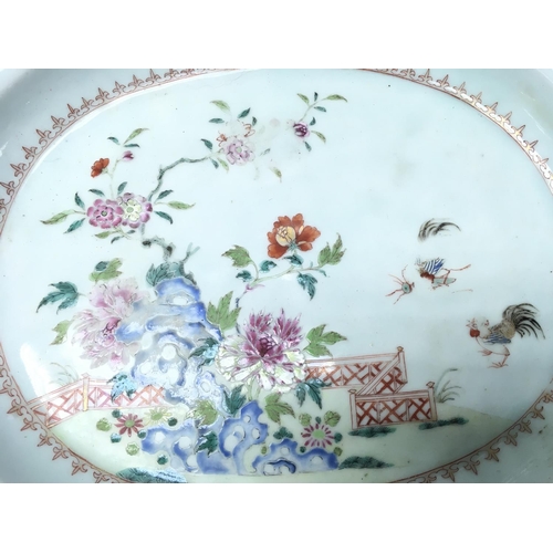 1023 - A Chinese Famille Rose style dish decorated with floral patterns and cockerels. 37.5cm wide. Postage... 