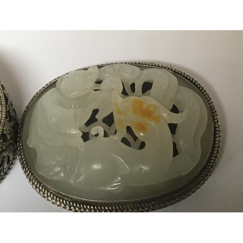 1030 - A Chinese white metal and jade mounted box of oval shape with a detachable lid the side with blind f... 