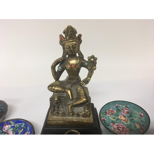 1042 - A Chinese Temple goddess gilded hollow bronze with applied turquoise on a hardwood base a small porc... 