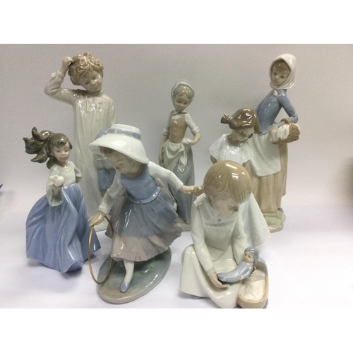 1241 - A collection of Lladro and Nao figures. Shipping category D.