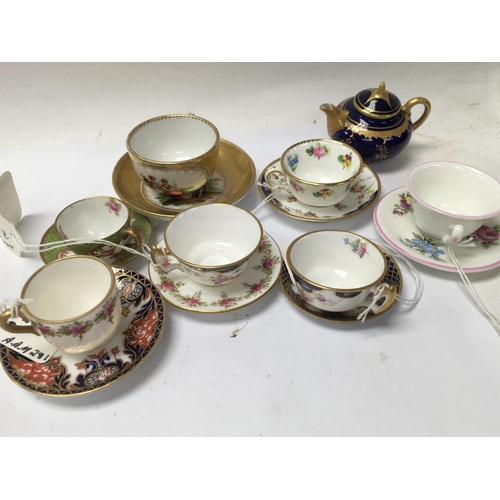 1250 - A Collection of miniature teapotâs milk jugs and cups and saucers including Royal Crown Derby and ... 