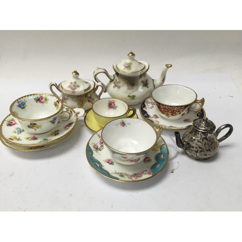 1250 - A Collection of miniature teapotâs milk jugs and cups and saucers including Royal Crown Derby and ... 