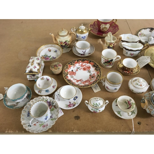 1263 - A collection of miniature cups and saucers including Derby and Dresden.