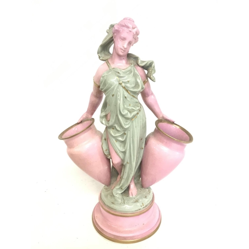 1267 - A Minton style porcelain figure of a woman with a pair of urns. 27cm tall. No obvious damage postage... 