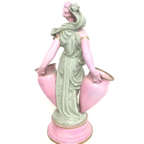 1267 - A Minton style porcelain figure of a woman with a pair of urns. 27cm tall. No obvious damage postage... 