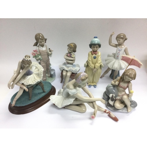 1321 - A collection of boxed Lladro and Nao figures plus two glass pig ornaments etc. Shipping category D.