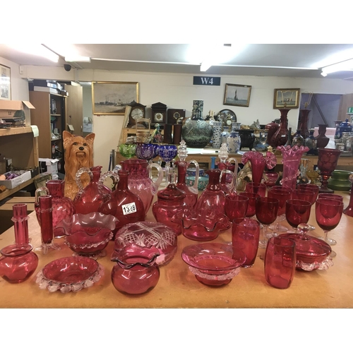 1328 - A large collection of Victorian cranberry glassware including decanters with stoppers, vases, jugs, ... 