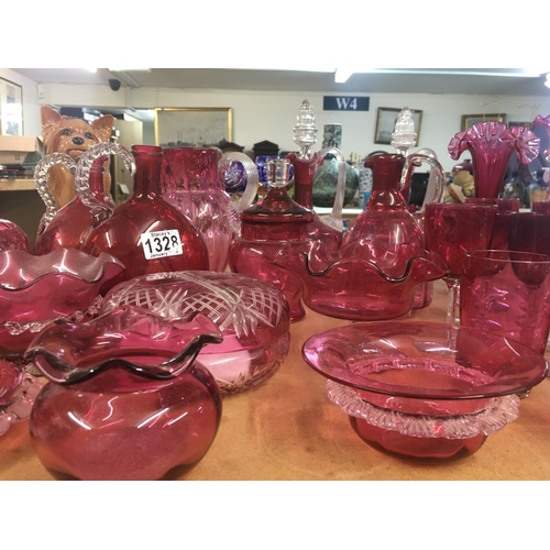 1328 - A large collection of Victorian cranberry glassware including decanters with stoppers, vases, jugs, ... 