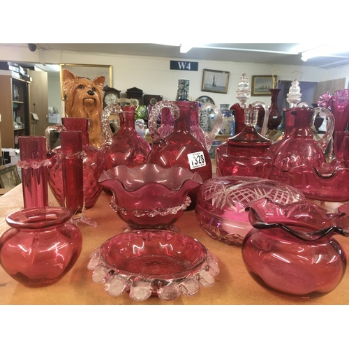 1328 - A large collection of Victorian cranberry glassware including decanters with stoppers, vases, jugs, ... 