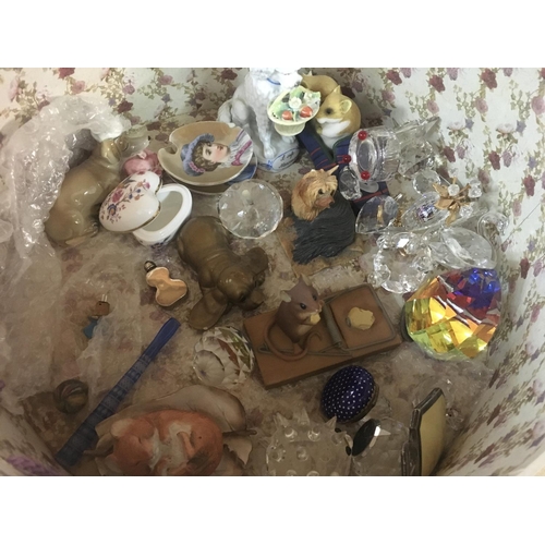 1334 - A hatbox containing various trinkets including Swarovski Crystal animals, glass tulips, bird figurin... 