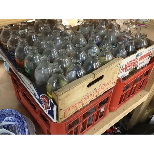 1345 - A collection of vintage Unigate milk bottles with various advertisements. Postage category D