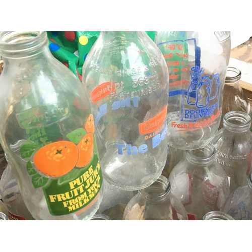 1345 - A collection of vintage Unigate milk bottles with various advertisements. Postage category D