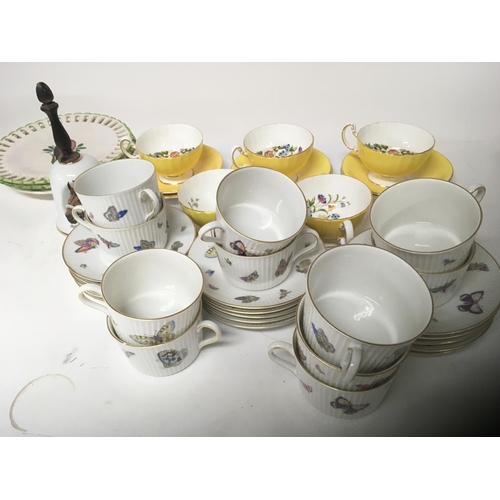 1354 - A decorative Anynsley porcelain tea set yellow glazed decorated with flowers and foliage.one other c... 