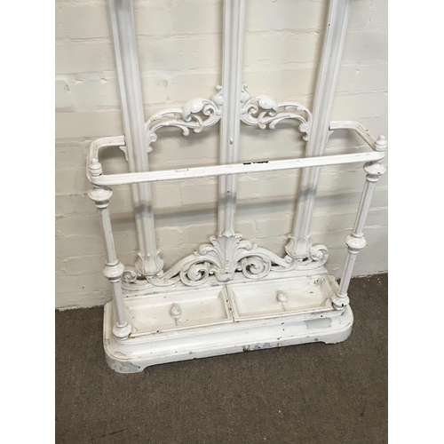 1400 - A late Victorian Cast iron hall stand with an arched top and scroll coat hook with an open compartme... 