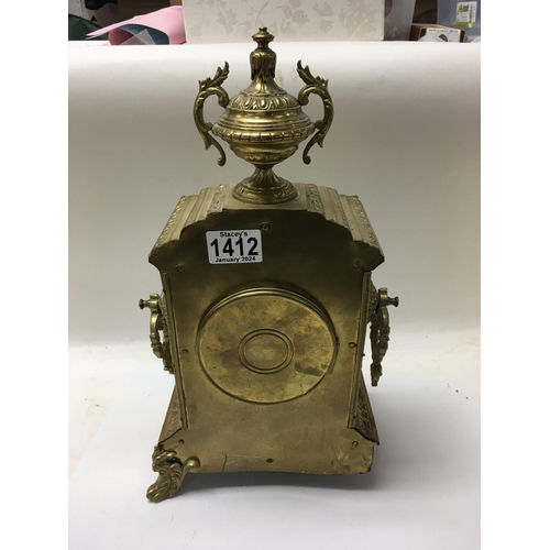 1412 - A Victorian brass mantle clock with Arabic numerals in a classic style.