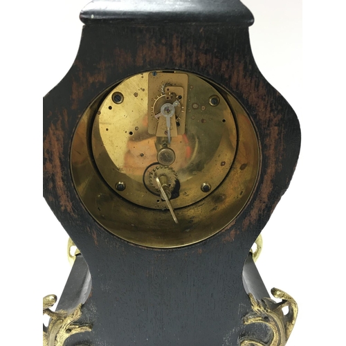 1415 - A boulle style mantle clock with a Roman numeral dial.