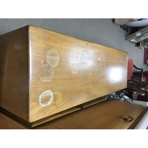 1523 - A Ercol sideboard with three cupboards and two drawers .