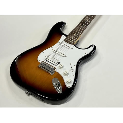 2396 - A Squier Stratocaster guitar in Fender Tweed Case in as new condition. Shipping category D.