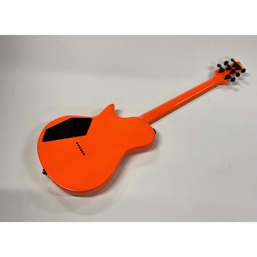 2399 - A Vibracell Switch Electric Guitar in bright orange finish -largely unplayed - comes with gigbag, le... 