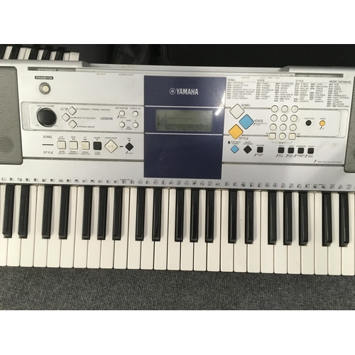 2404 - A pair of Yamaha Portable Keyboards comprising one boxed and one loose. Shipping category D.