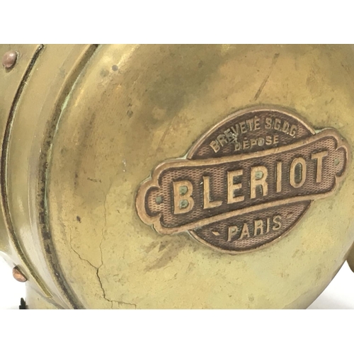 922 - An early brass Bleriot Paris car paraffin lamp and an AA badge. 25cm tall. Postage category D