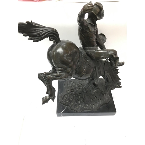 934 - A Remington style bronze figure displayed on marble. 48cm tall. Postage category D