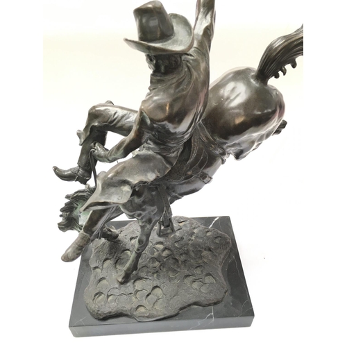 934 - A Remington style bronze figure displayed on marble. 48cm tall. Postage category D