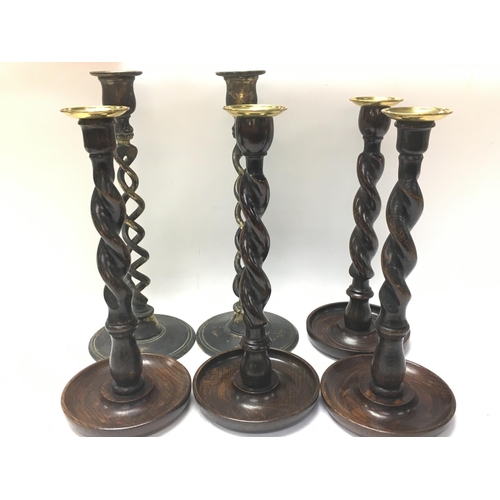 949 - A collection of candlesticks including wood and brass , postage category C