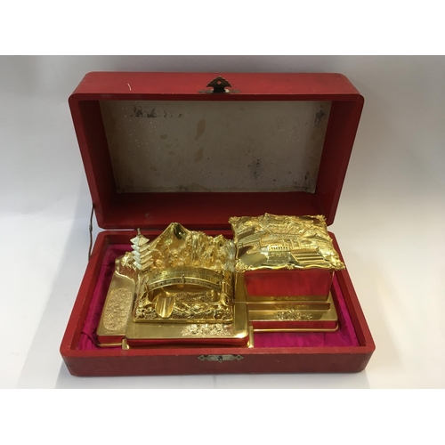 954 - A cased Japanese gilt metal desk stand music box, 21.5cm x 12cm x 7.5cm