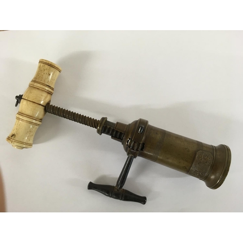 956 - A brass barrel cork screw with bone handle