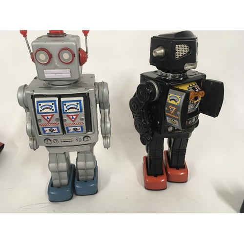 103 - A pair of tinplate model battery operated robots with numerous features. One marked made in Japan th... 