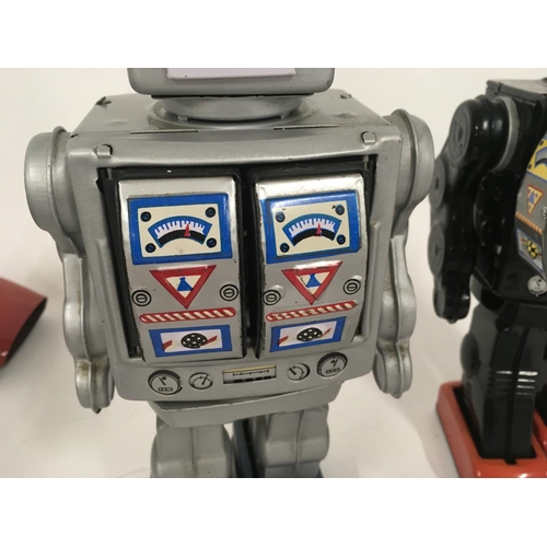 103 - A pair of tinplate model battery operated robots with numerous features. One marked made in Japan th... 