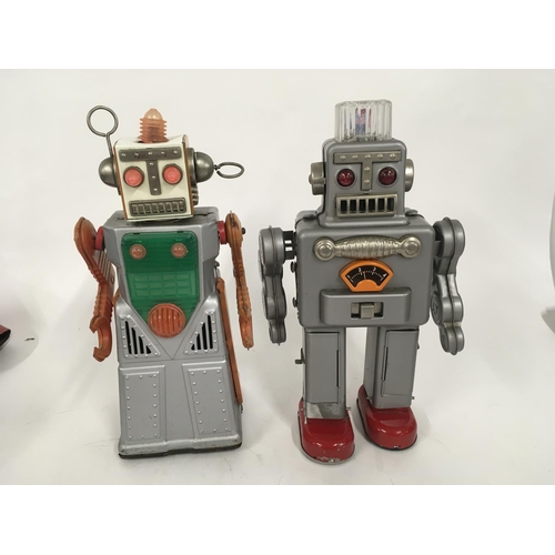 104 - A pair of tinplate battery operated robots one marked HaHa toys and the other HK made in Japan.