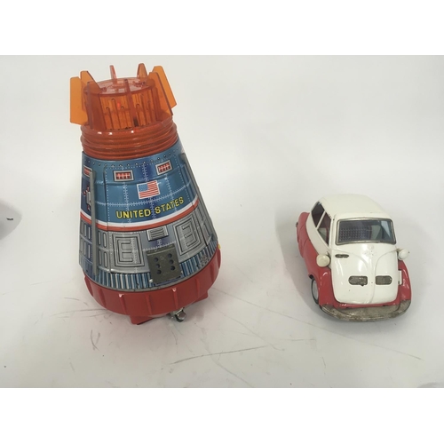 107 - A pair of tinplate toys one Space Capsule battery operated made in Japan by SH. One Isetta bubble ca... 