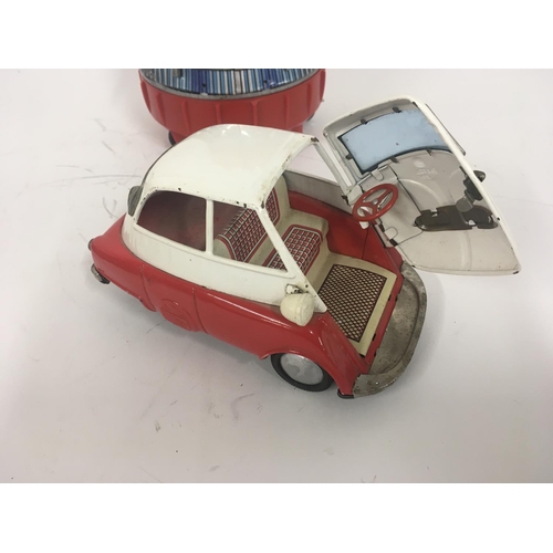 107 - A pair of tinplate toys one Space Capsule battery operated made in Japan by SH. One Isetta bubble ca... 