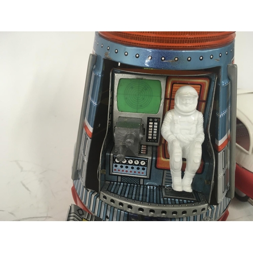 107 - A pair of tinplate toys one Space Capsule battery operated made in Japan by SH. One Isetta bubble ca... 