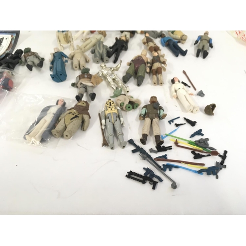 122 - A collection of vintage STAR WARS figures . Also includes accessories ..post cards..weapons and back... 